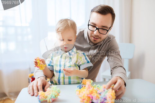 Image of father and son playing with ball clay at home