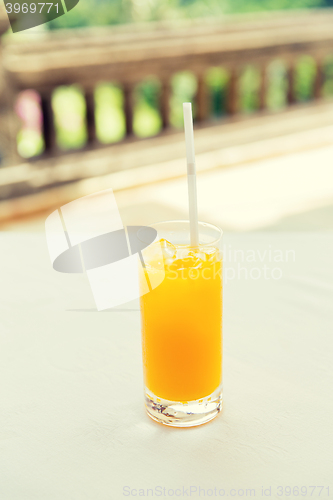 Image of glass of fresh orange fruit juice at restaurant