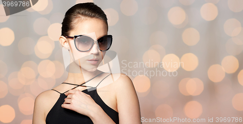 Image of beautiful young woman in elegant black sunglasses