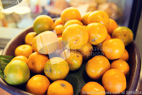 Image of basket of fresh ripe juicy oranges at kitchen