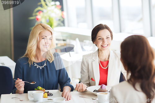 Image of women eating dessert and talking at restaurant