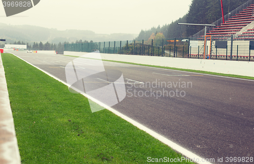 Image of close up of speedway track or road and stands