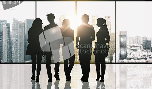 Image of people silhouettes over window and city background
