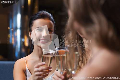 Image of happy women with champagne glasses at night club