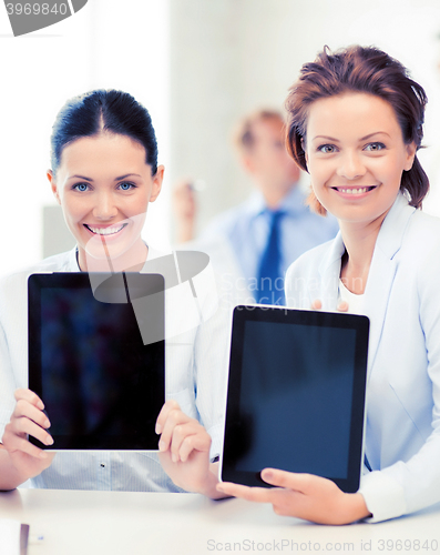 Image of business team showing tablet pcs in office