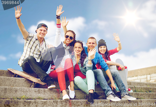 Image of group of smiling teenagers hanging out