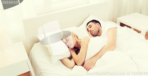 Image of happy couple sleeping in bed at home