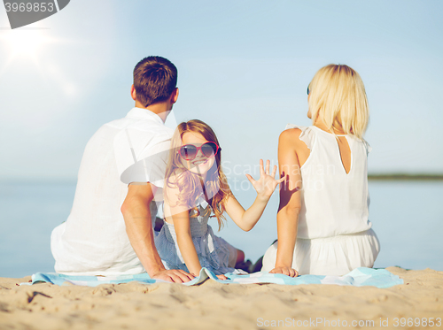 Image of happy family on the beach