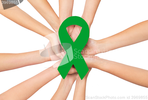 Image of close up of hands with green awareness ribbon