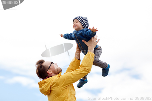 Image of father with son playing and having fun outdoors