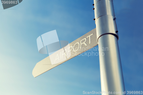 Image of close up of airport signpost over blue sky