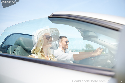 Image of happy man and woman driving in cabriolet car