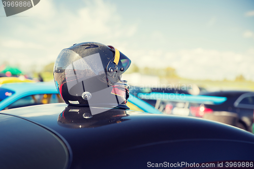 Image of close up of car with helmet on roof top