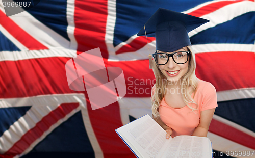 Image of student woman in mortarboard over english flag