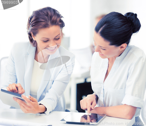Image of business team working with tablet pc in office