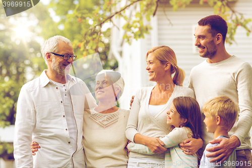 Image of happy family in front of house outdoors