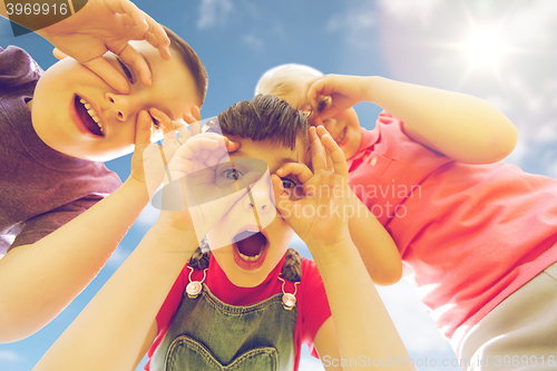 Image of group of kids having fun and making faces outdoors