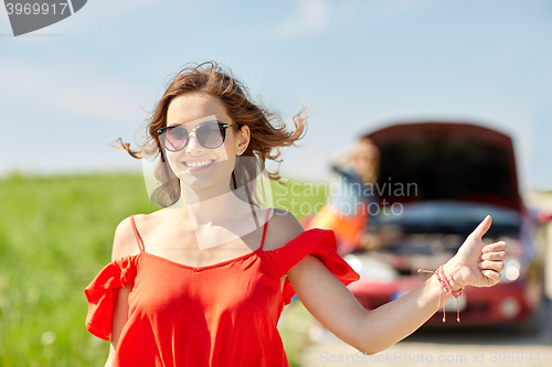 Image of women with broken car hitchhiking at countryside