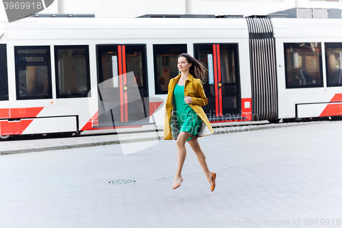 Image of happy young woman or teenage girl on city street