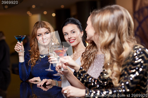 Image of happy women with drinks at night club