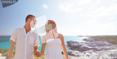 Image of happy smiling couple over summer beach and sea