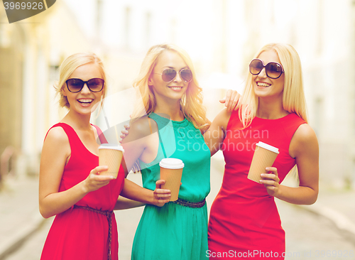 Image of women with takeaway coffee cups in the city