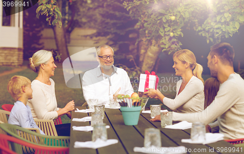 Image of happy family having holiday dinner outdoors