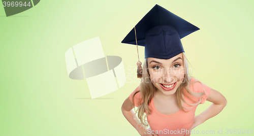 Image of smiling young student woman in mortarboard