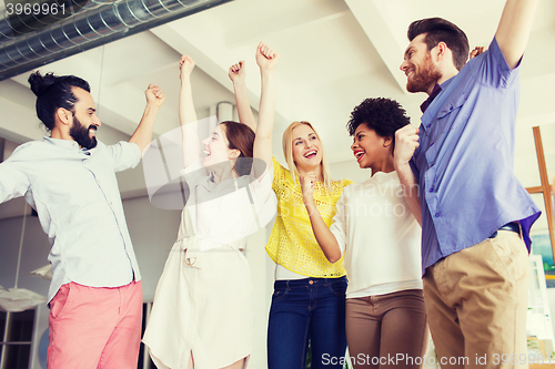 Image of happy creative team in office