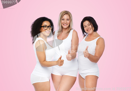 Image of group of happy plus size women showing thumbs up