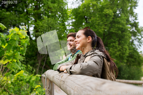 Image of smiling couple with backpacks in nature