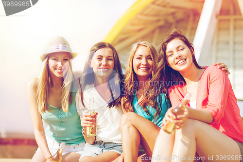 Image of girls with drinks on the beach