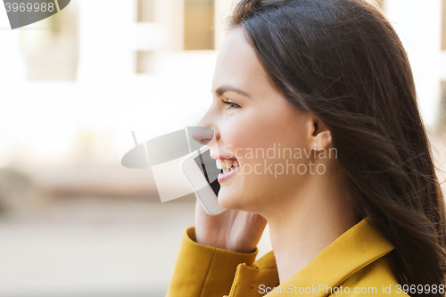 Image of smiling young woman or girl calling on smartphone