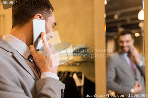 Image of close up of man calling on cellphone at store