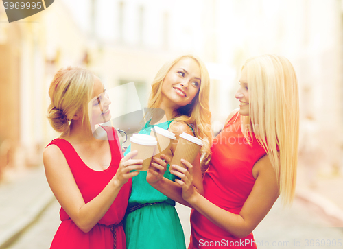 Image of women with takeaway coffee cups in the city