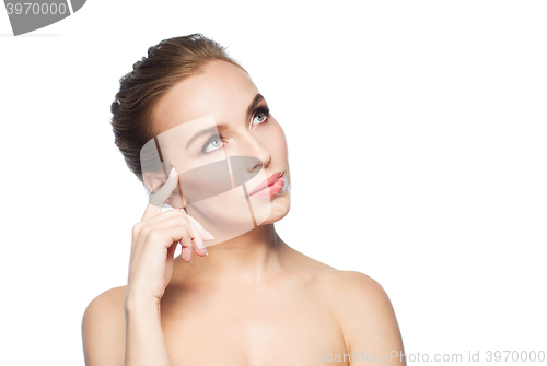 Image of beautiful young woman touching her face