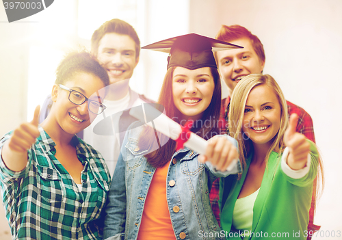 Image of student girl in graduation cap with diploma