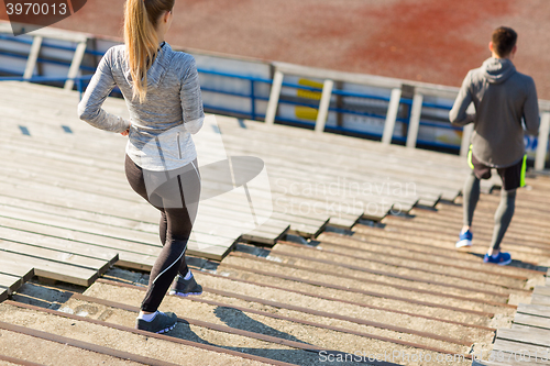 Image of close up of couple running downstairs on stadium