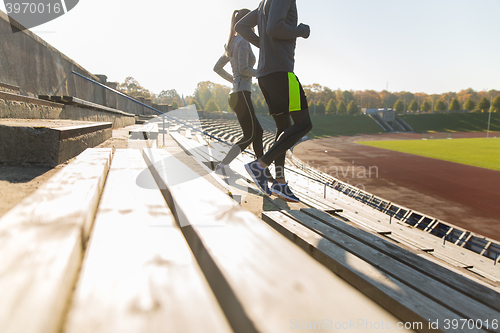 Image of close up of couple running downstairs on stadium