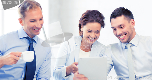 Image of business team having fun with tablet pc in office