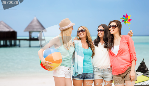 Image of smiling girls in shades having fun on the beach