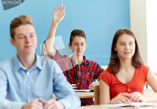 Image of group of students with notebooks at school lesson