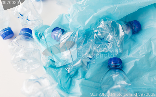 Image of close up of used plastic bottles and rubbish bag