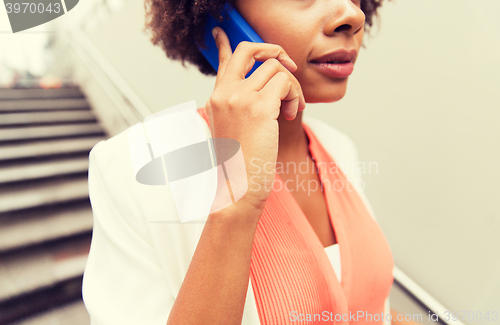Image of close up of african woman calling on smartphone