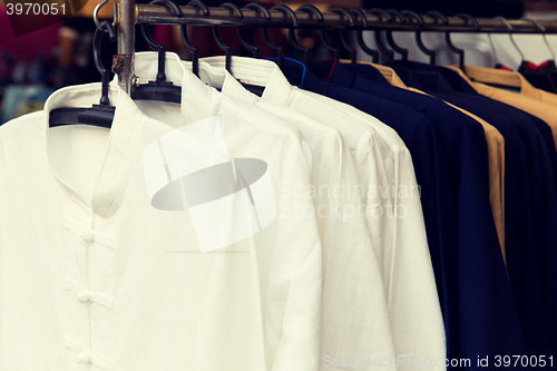 Image of male shirts on hanger at asian street market