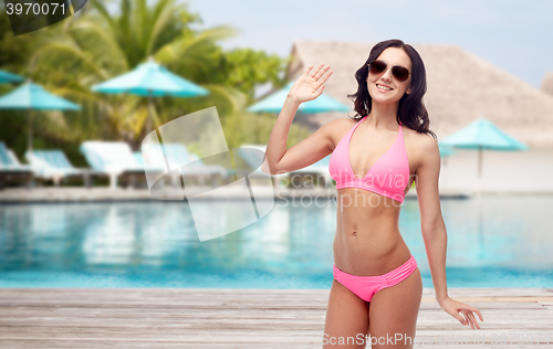 Image of happy woman in sunglasses and bikini swimsuit