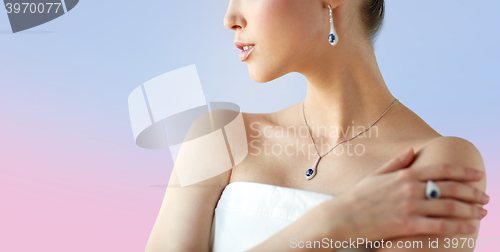 Image of beautiful woman with earring, ring and pendant