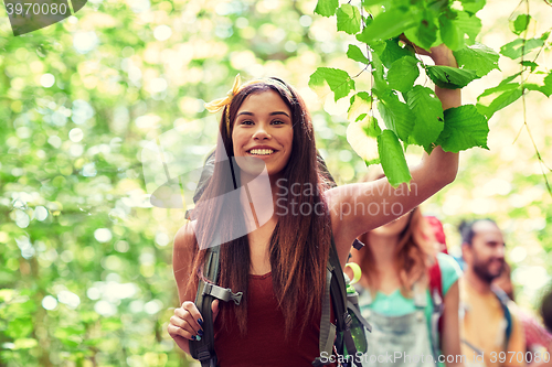 Image of group of smiling friends with backpacks hiking