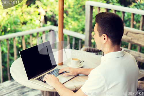 Image of close up of businessman with laptop on terrace