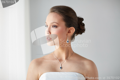 Image of beautiful asian woman with earring and pendant